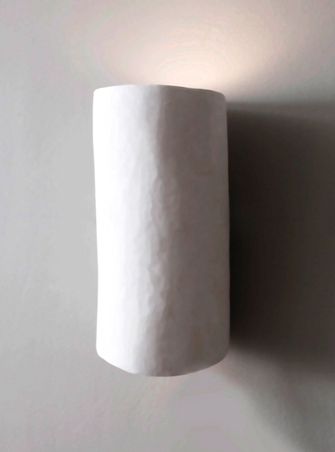 Curved and sculpted in plaster, the Serenity wall light by Hannah Woodhouse is the perfect wall sconce for spas, hotels and residential interiors.